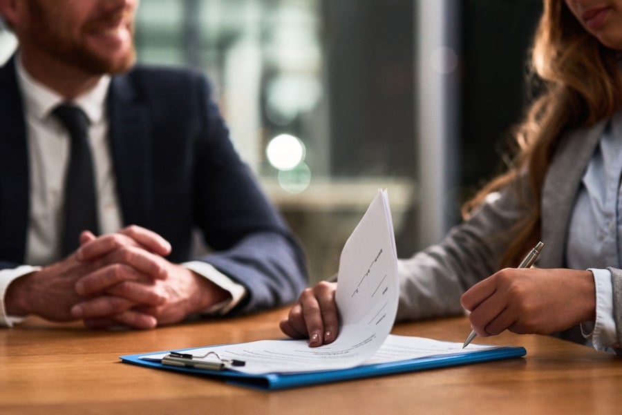 A man and woman discussing documents